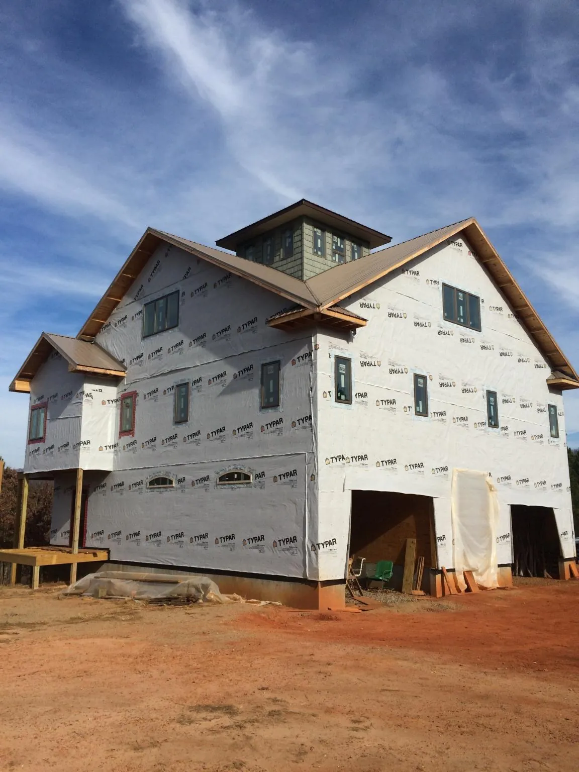 New two story house under construction with a cupola and gabled roofs in Lithia Springs